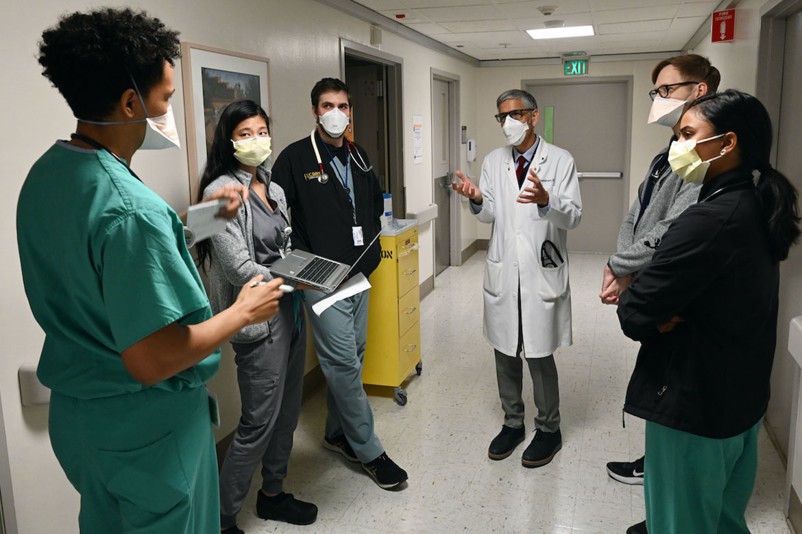 Mark C. Henderson, MD (center), speaks with University of California, Davis, health-professional trainees.