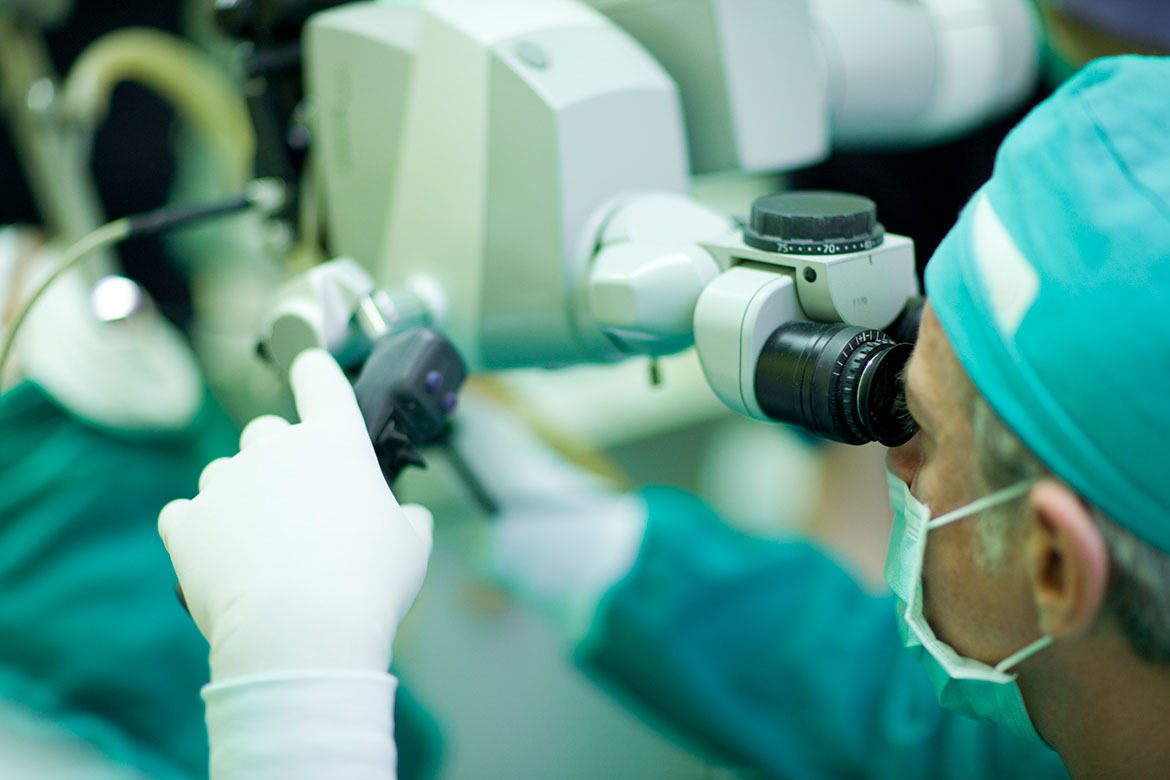 Health care professional performing laser surgery