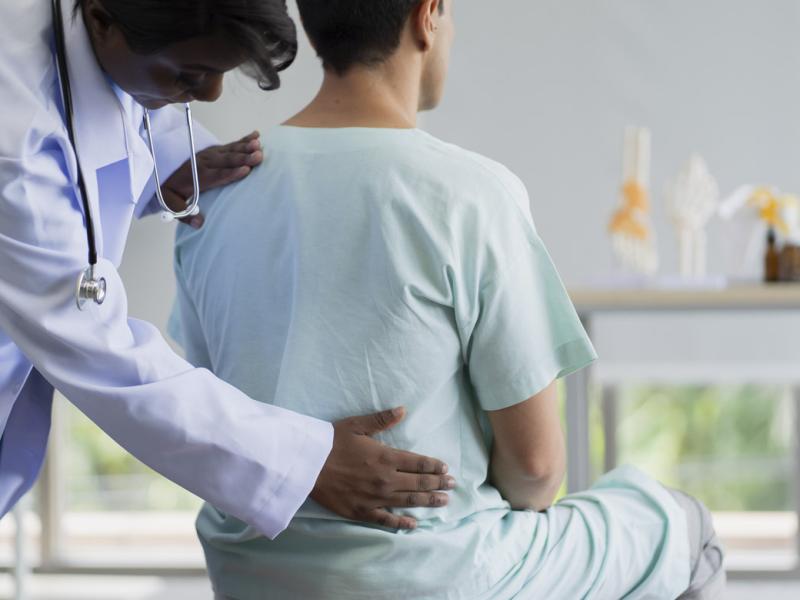 Physiotherapist assists patient