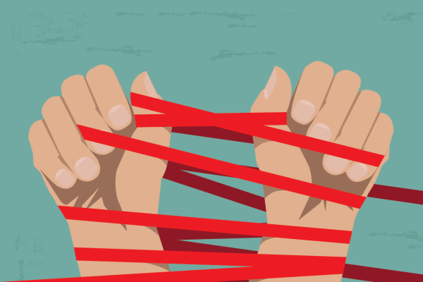 Pair of hands twined with red tape