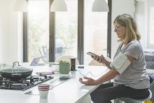 Woman monitors blood pressure at home