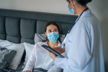 Health visitor with patient during nursing home visit