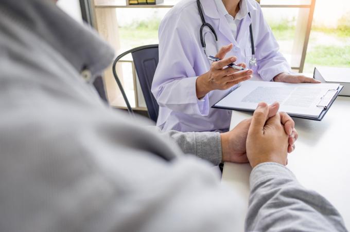 Physician and patient speaking in an office