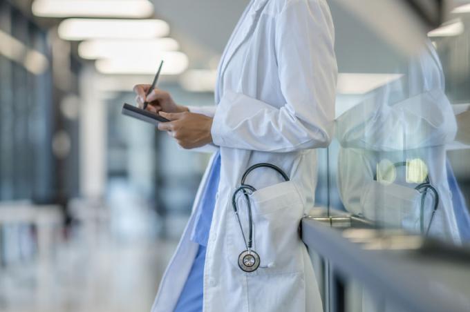 Physician reviews a chart in the lounge area of a hospital