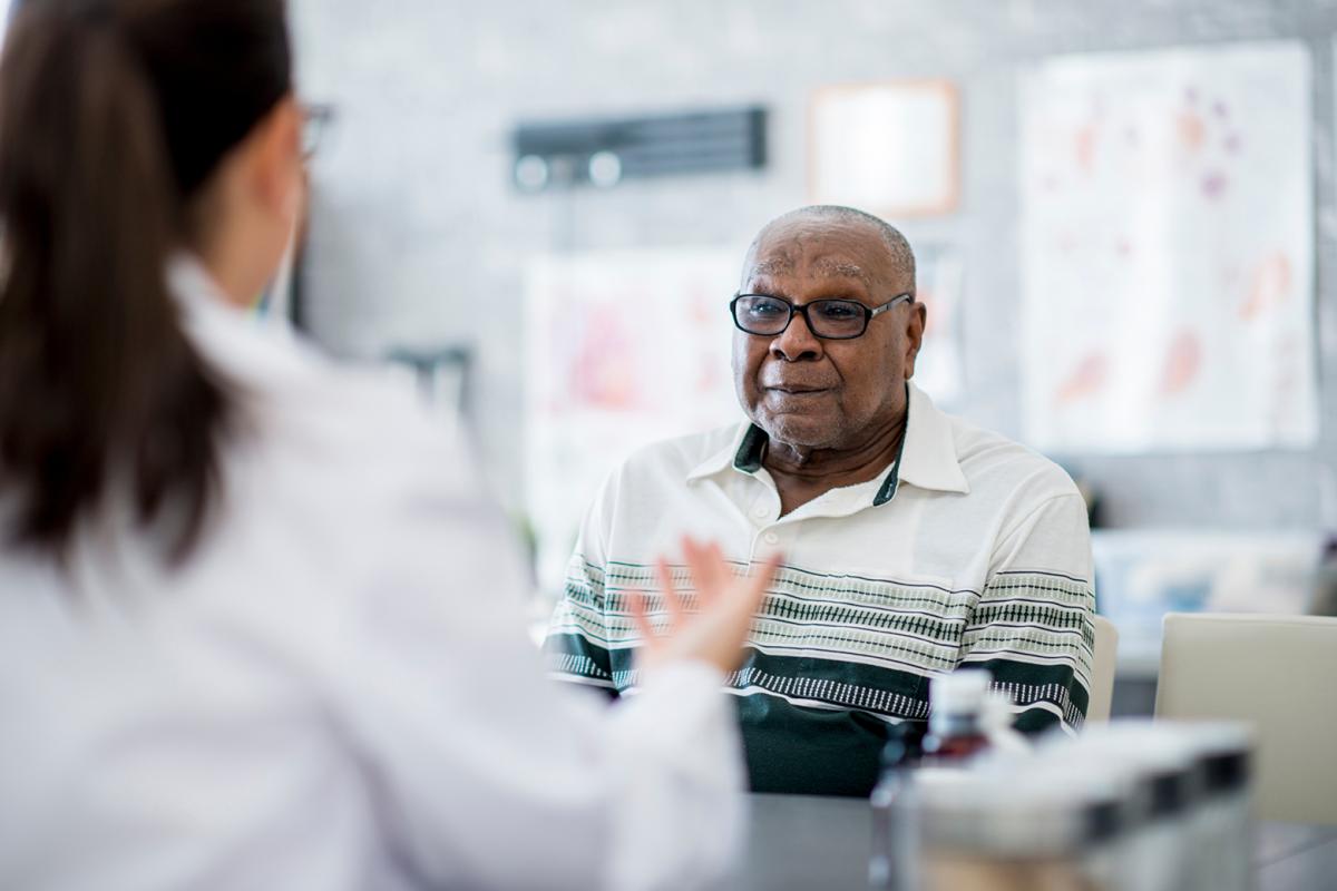 Physician talking with patient