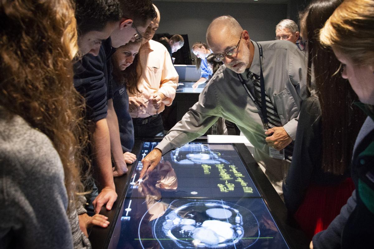 Doctor demonstrating virtual anatomy for students