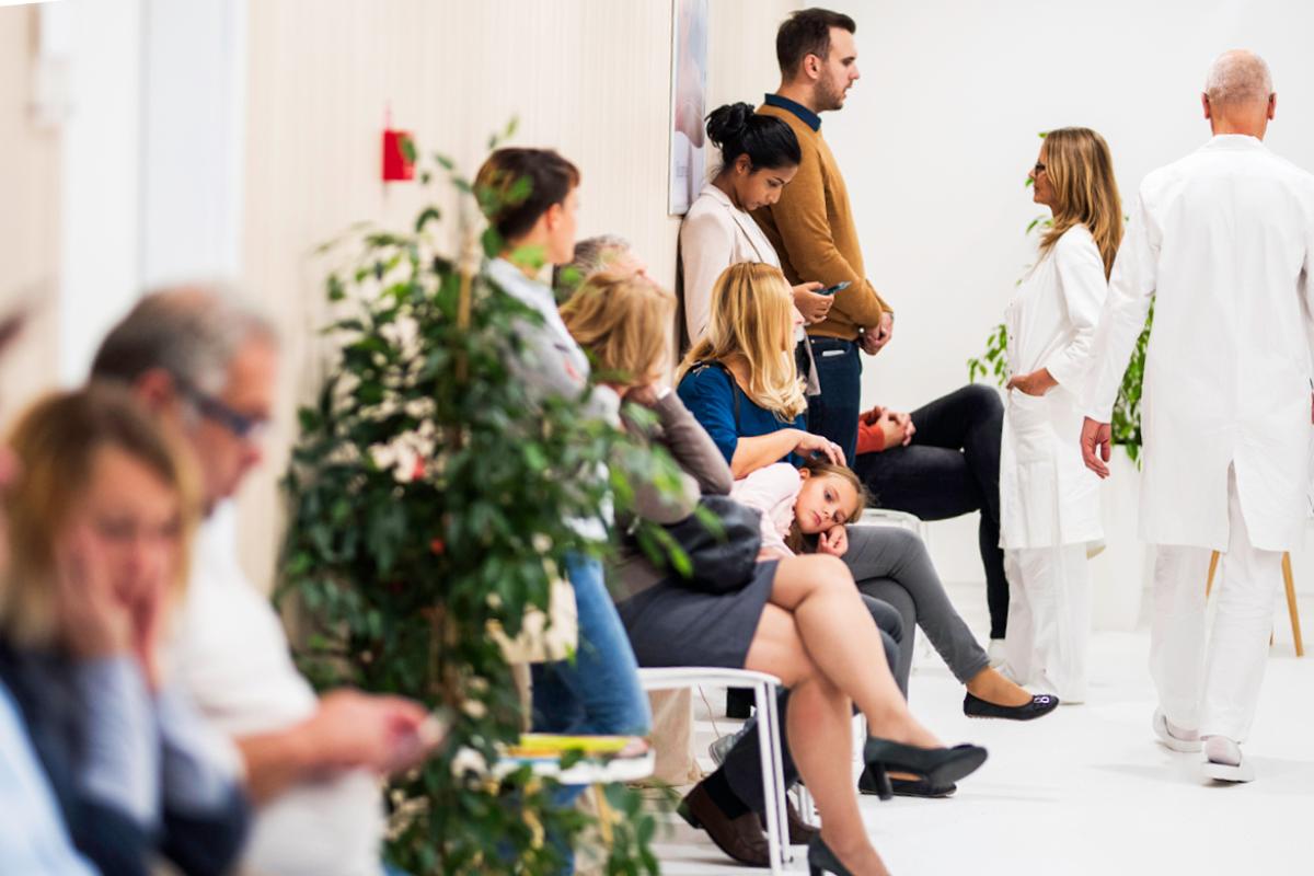 Long line of patients in waiting room