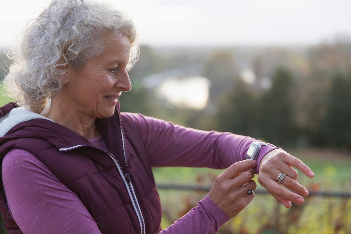 Woman looking at activity tracking watch