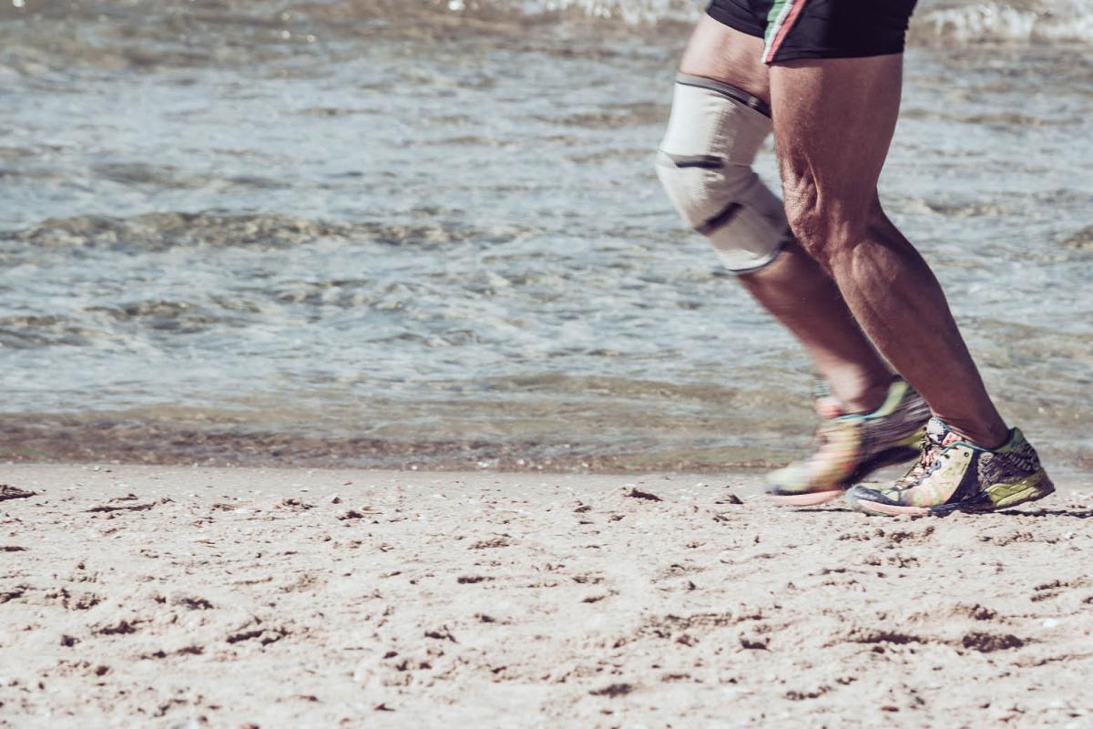 Person running along the beach