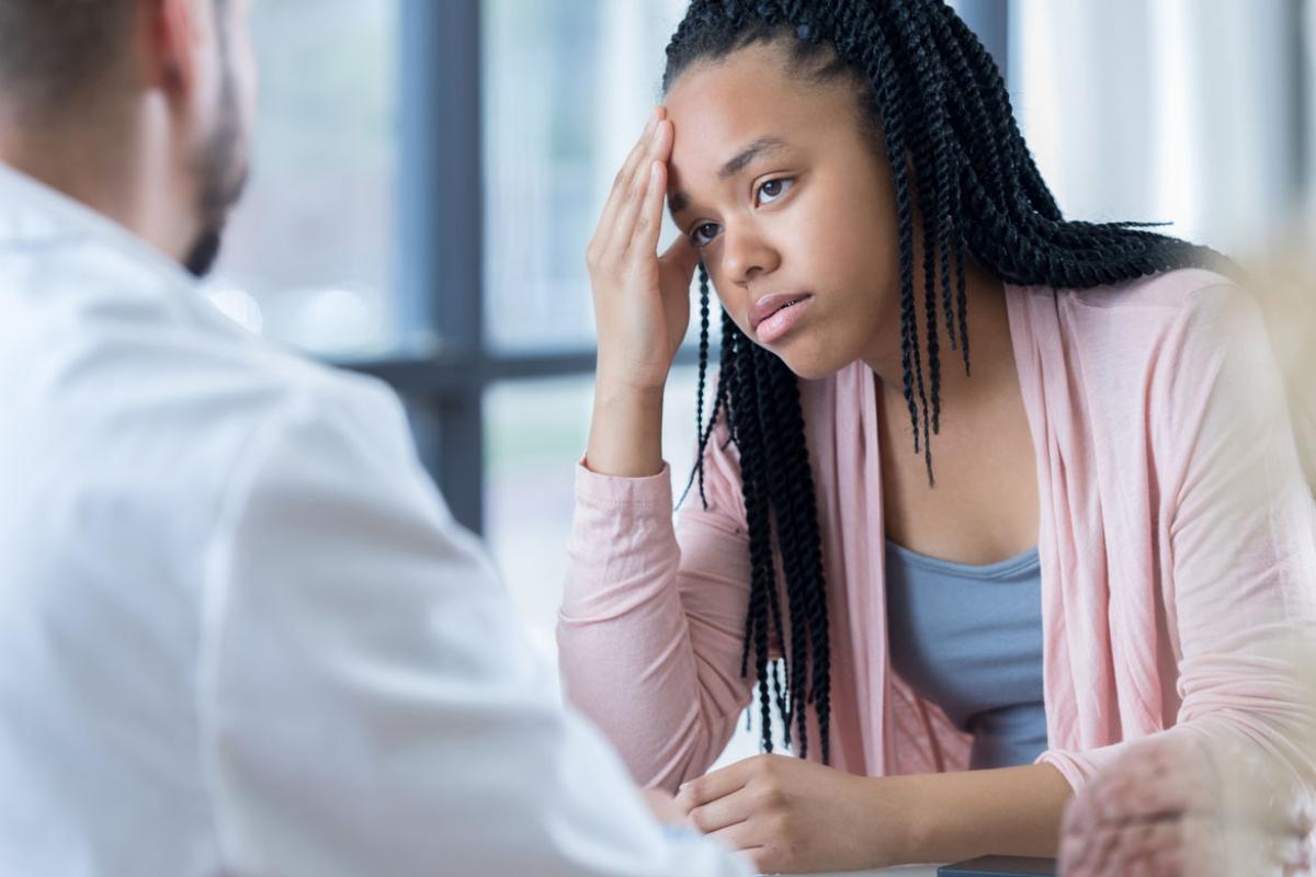 Doctor talking to teen girl