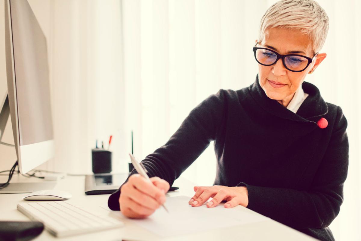 Woman writing on paper