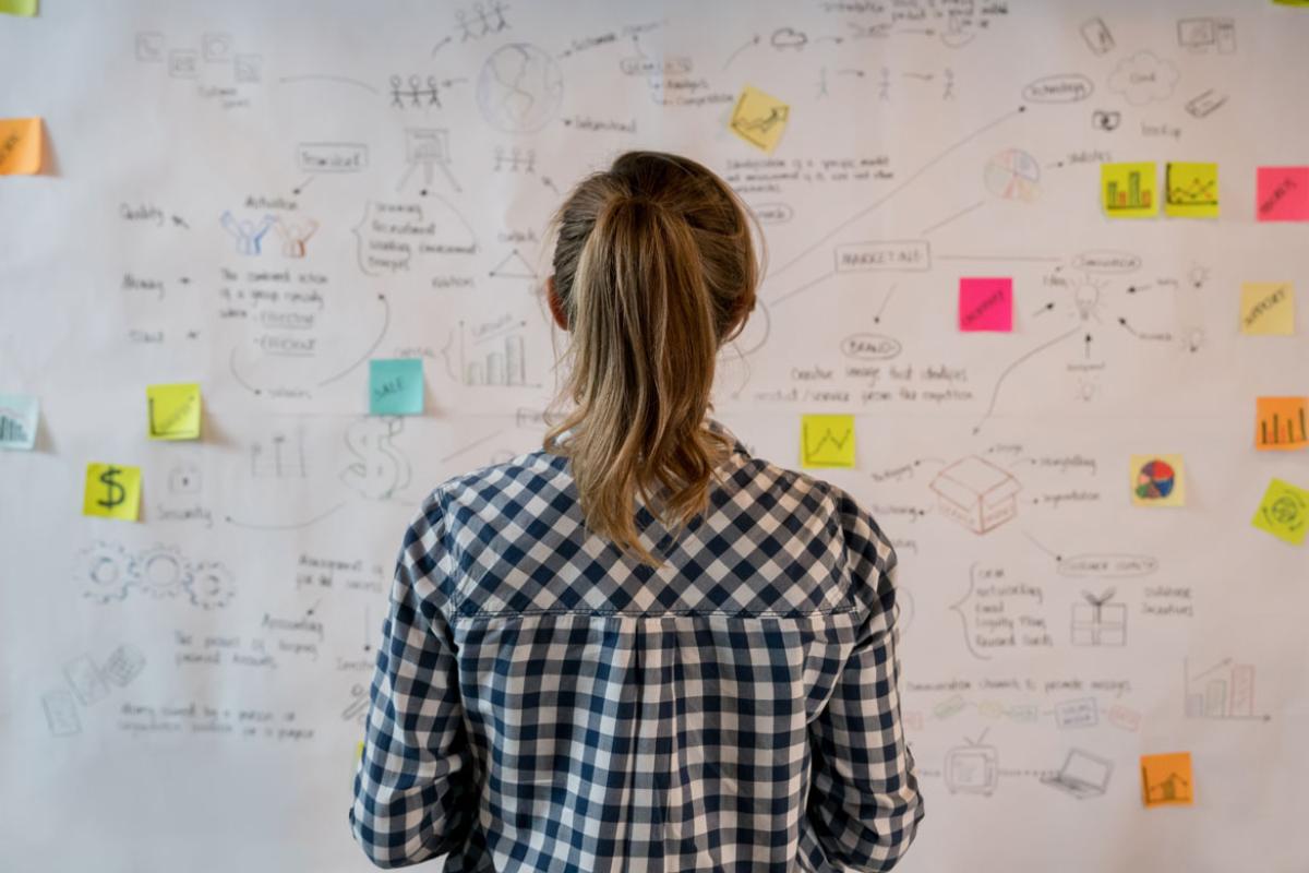 Woman standing in front of bulletin board