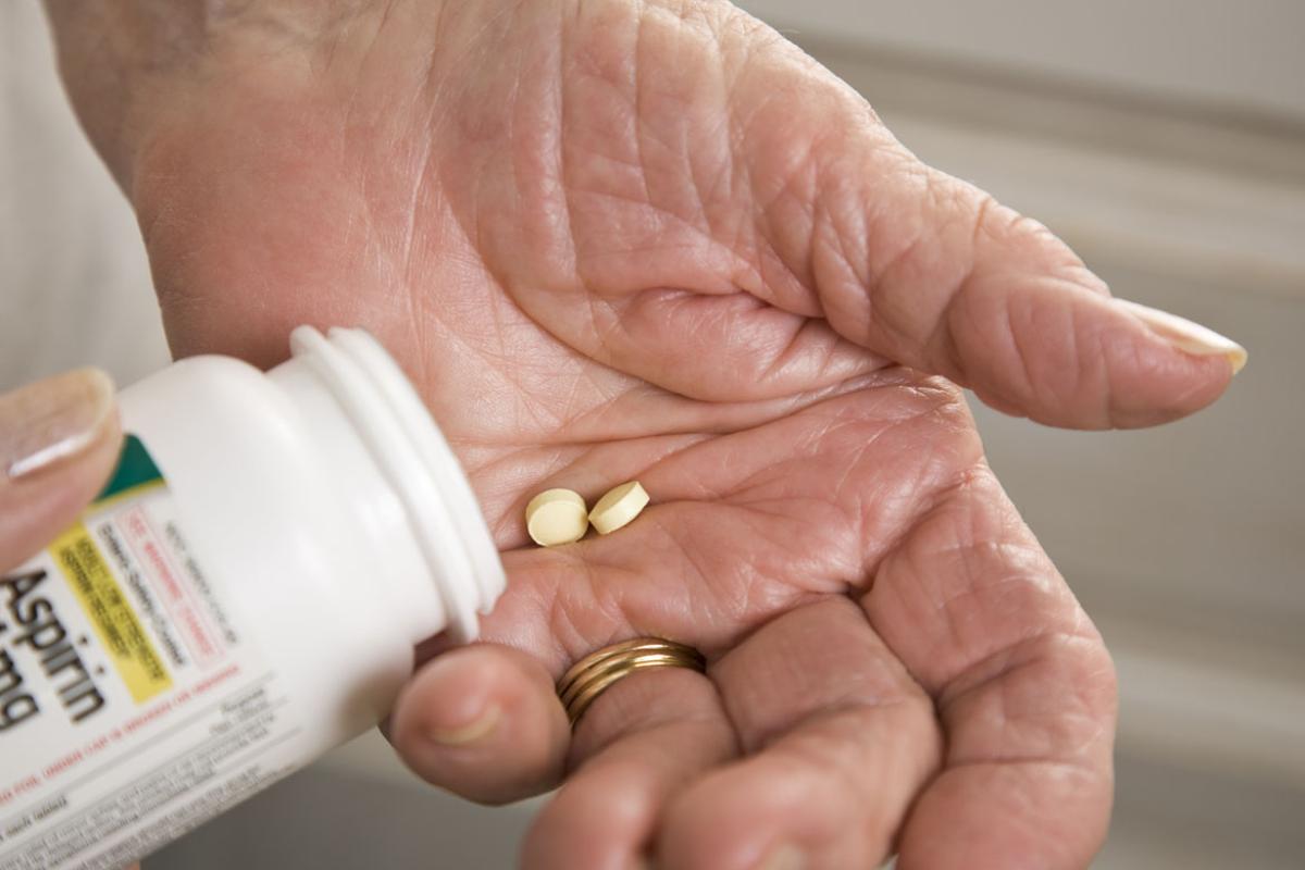 Aspirin in a person's hand