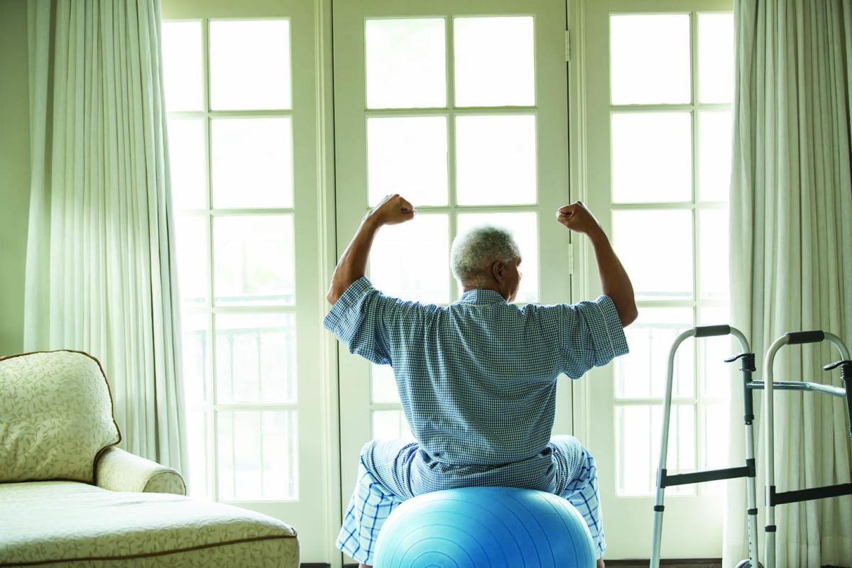 Patient sitting on an exercise ball next to a walker