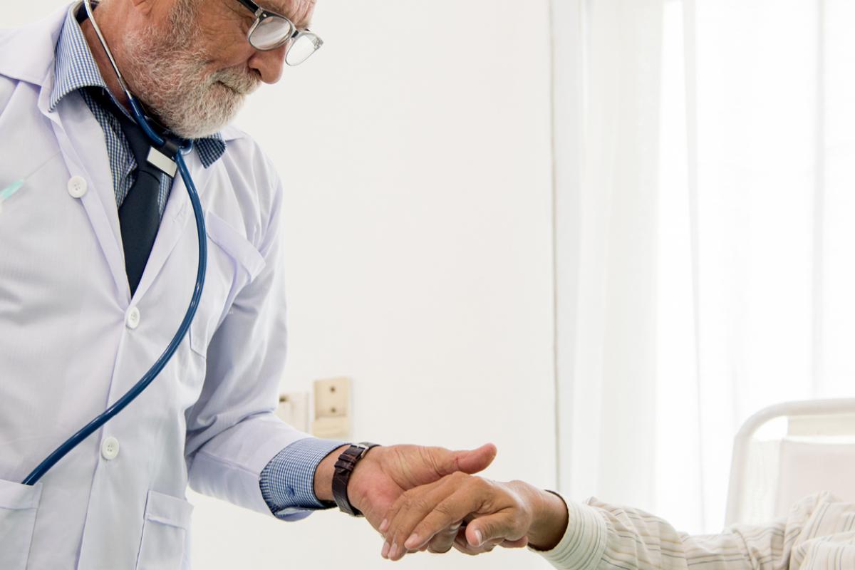 Physician holding a patient's hand
