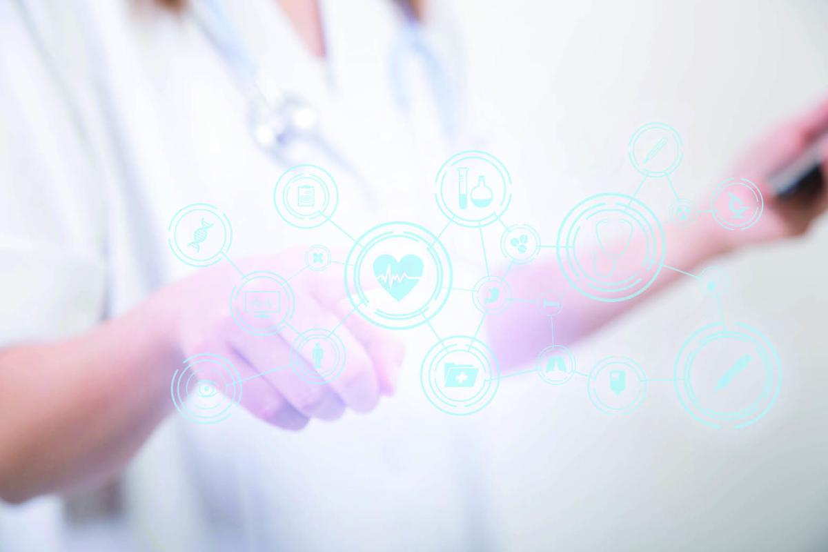 A physician touches symbols on a glass screen