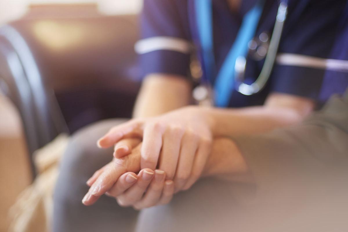 Physician holding a patient's hand