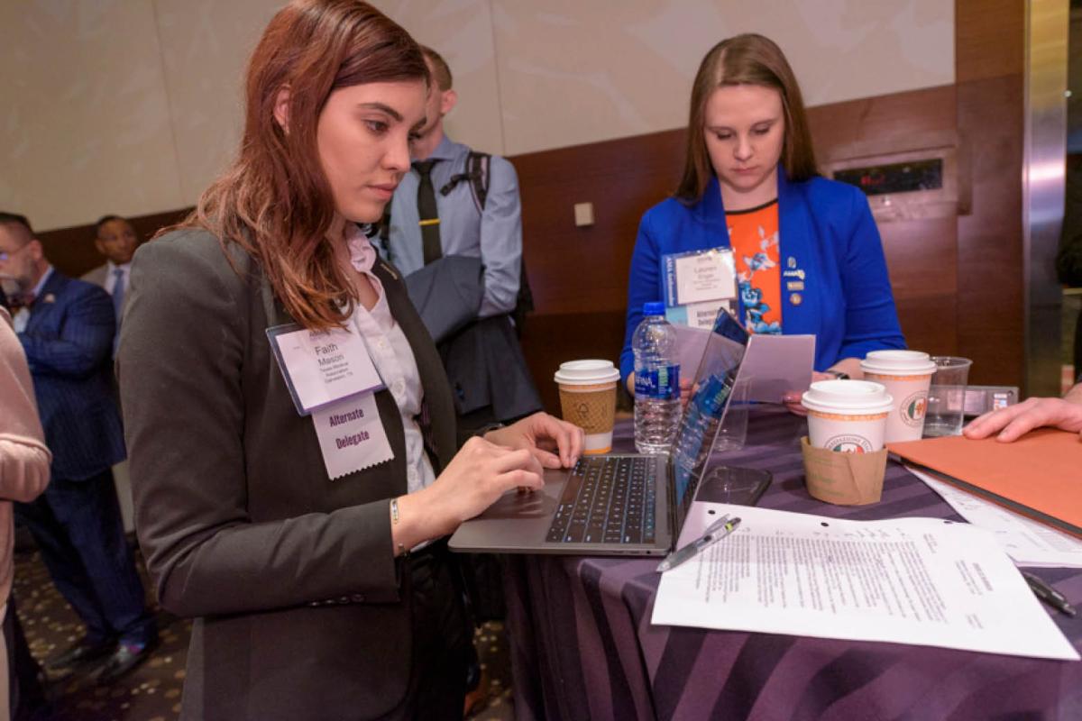 Delegates working at Annual Meeting