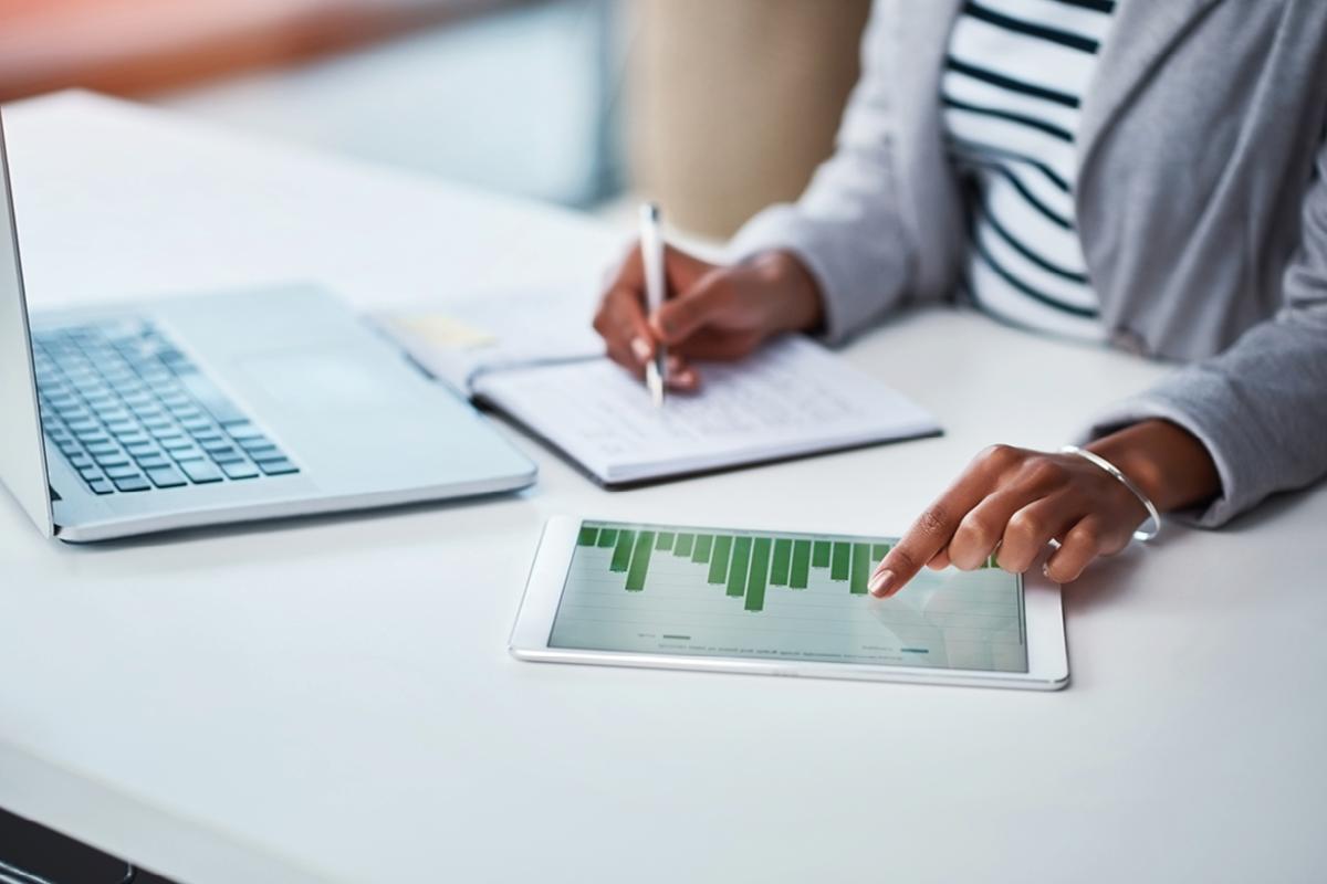 Tablet on a desk displaying a bar chart