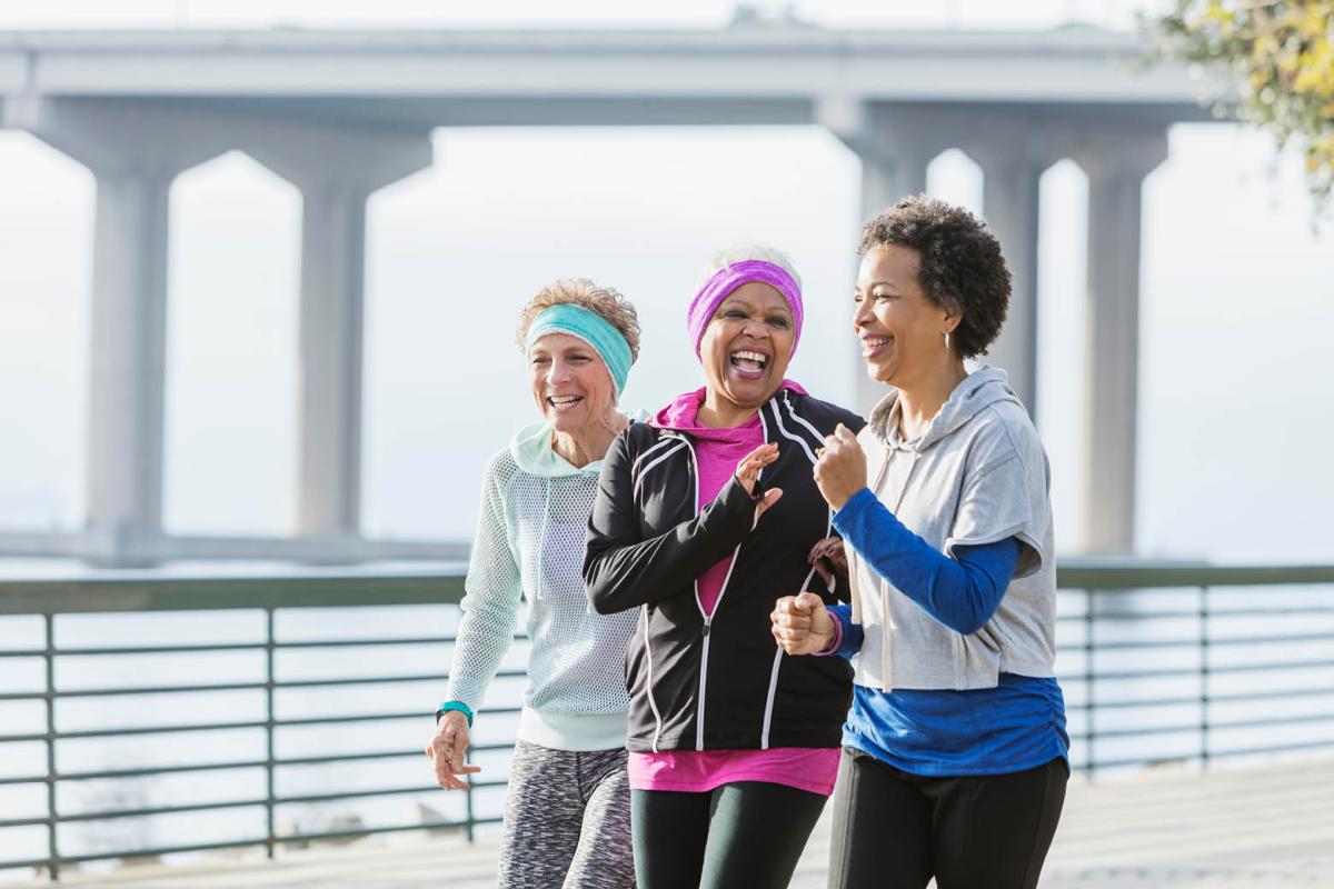 Three smiling women in workout clothes