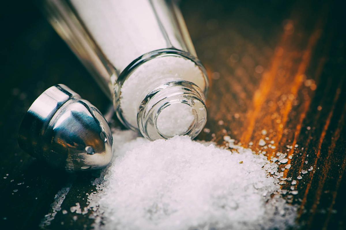 Spilled container of salt on a table