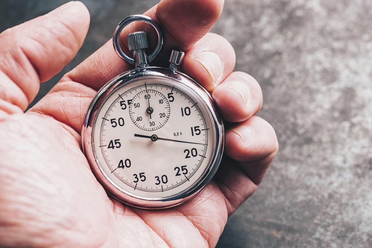 Tight shote of man holding a stopwatch in his hand
