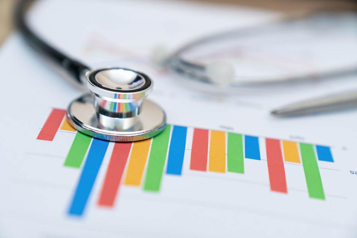A stethoscope on top of a bar chart
