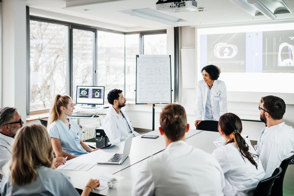 Female doctor presenting to a group of physicians