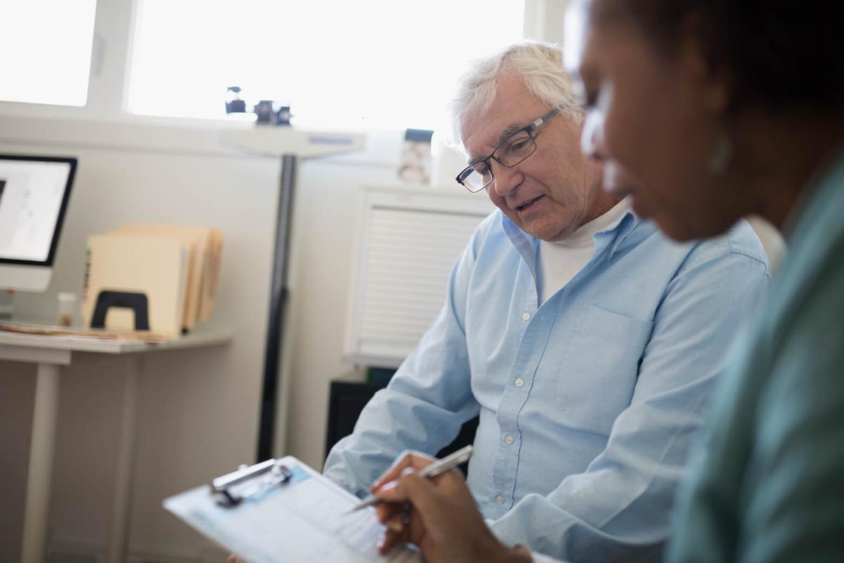 Physician going over a list with a patient