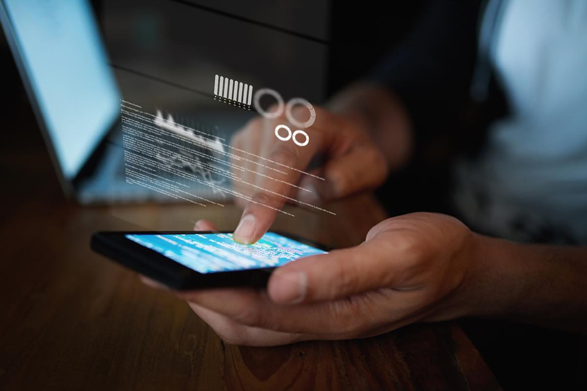 Data grid superimposed on man's finger as he scrolls the screen of a smartphone.