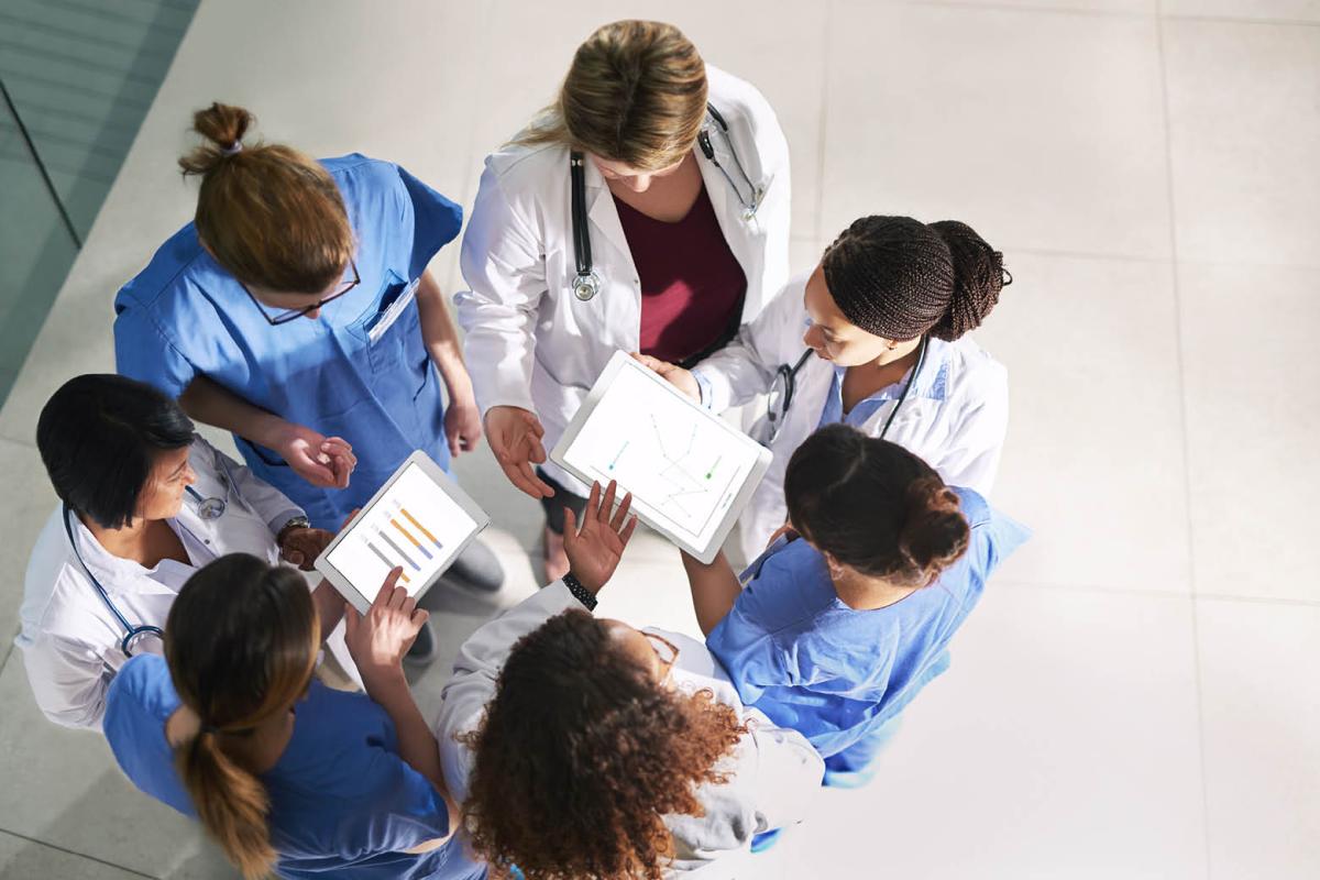 Group of doctors looking at tablets