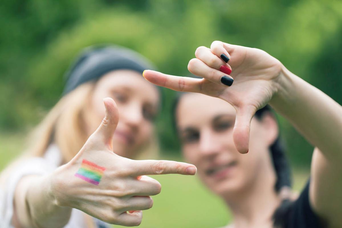 Two women forming a frame with their hands.