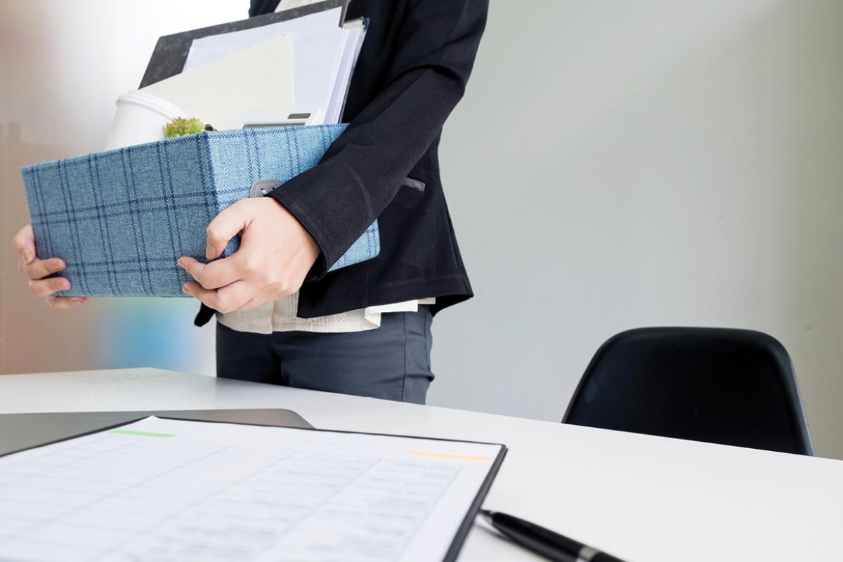 Person holding box of office supplies