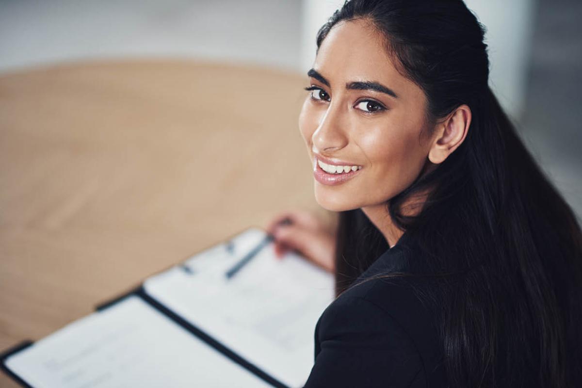 Woman looking up from reading a contract
