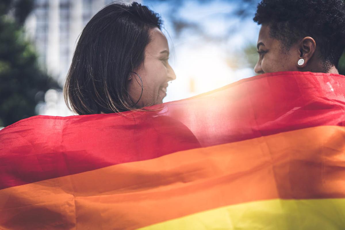 Smiling couple draped in a flag