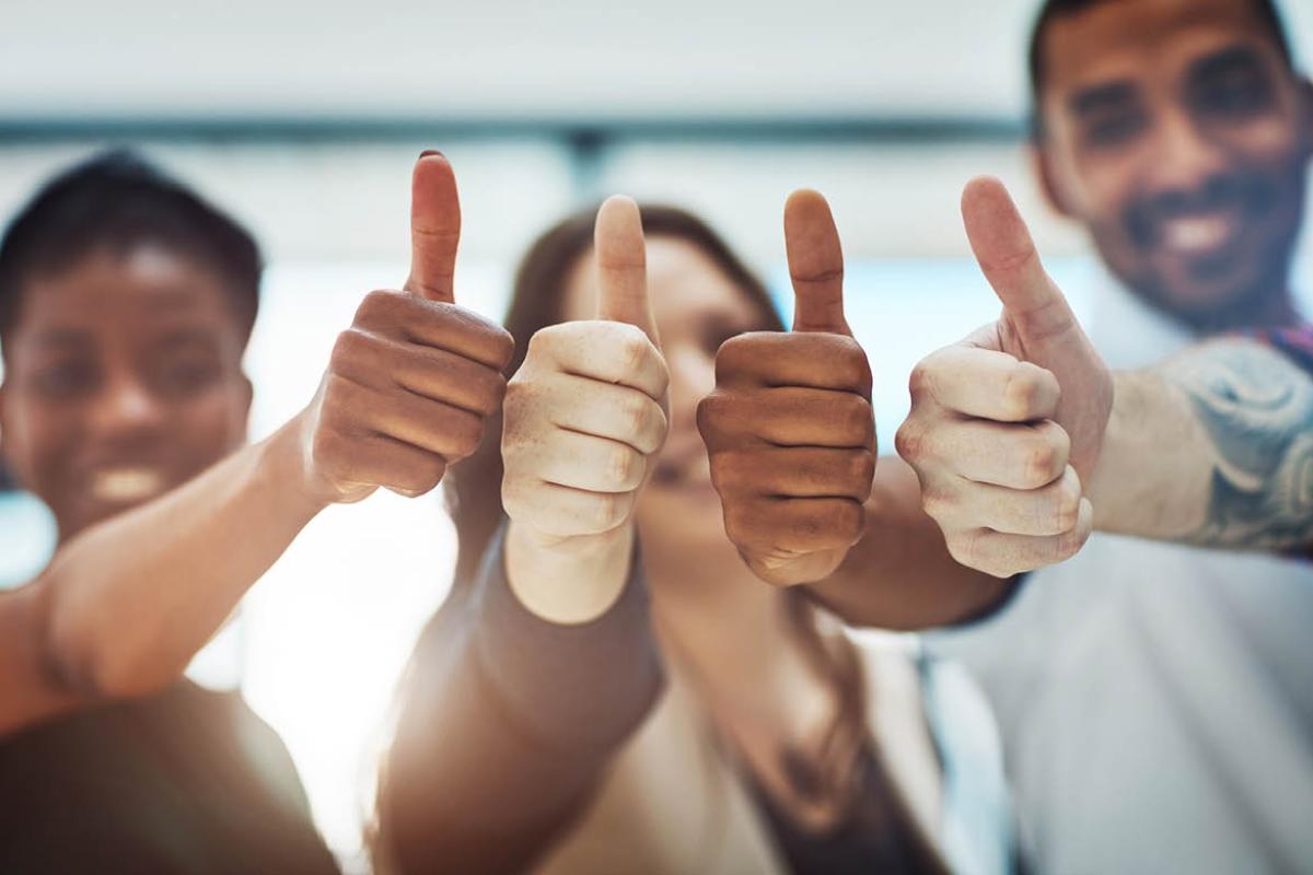 Group of people giving the thumbs up