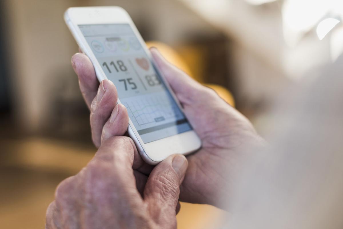Hands holding a smartphone using a mobile health app