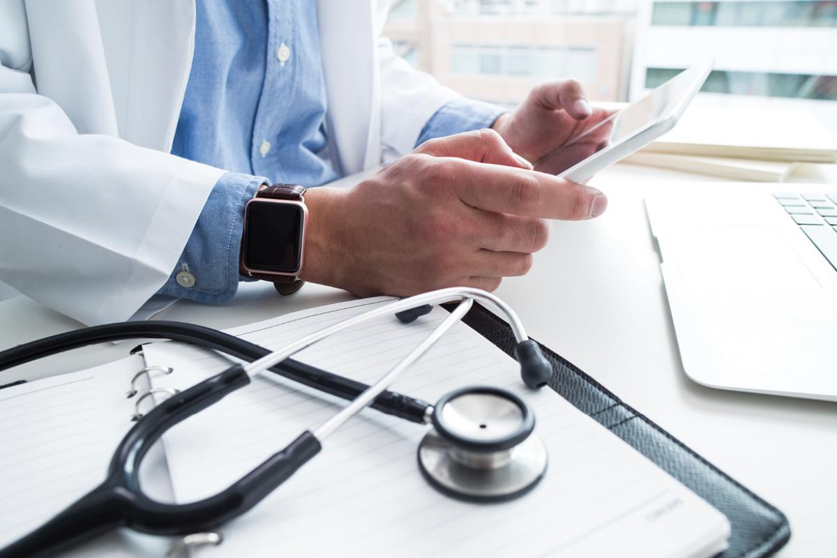 Physician holding a tablet