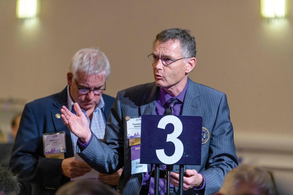 Delegate speaking at the microphone during the 2019 HOD Interim Meeting