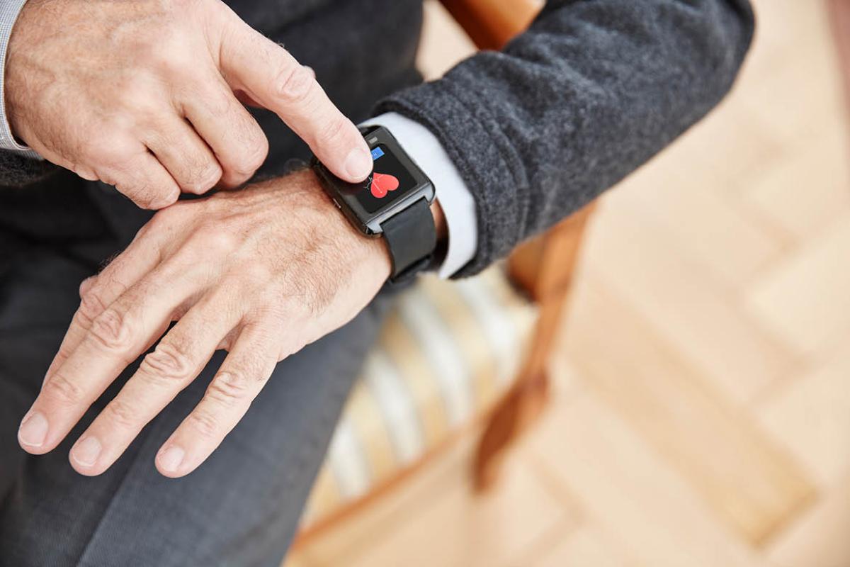 Man pointing at smart watch