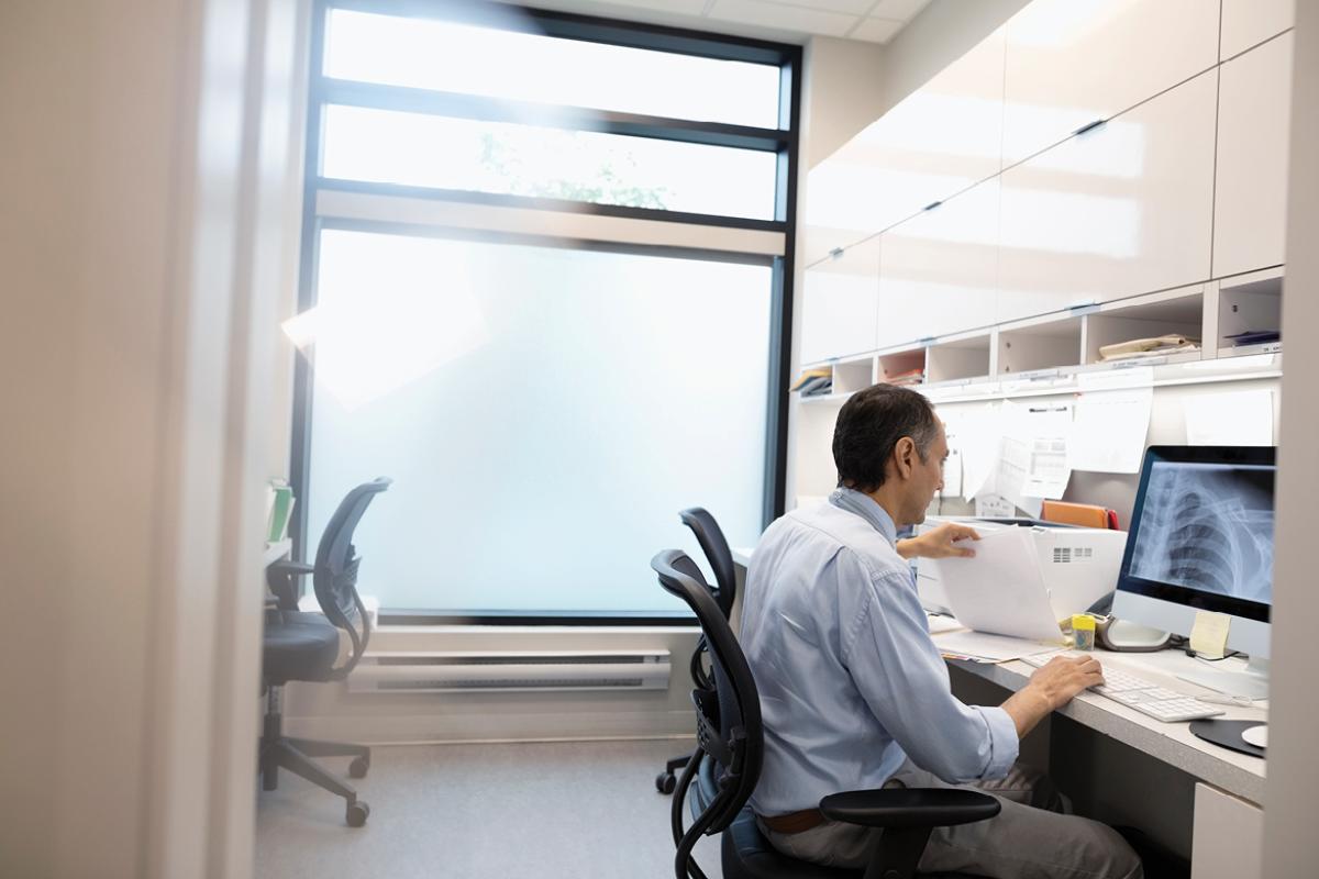 Physician working in front of computer