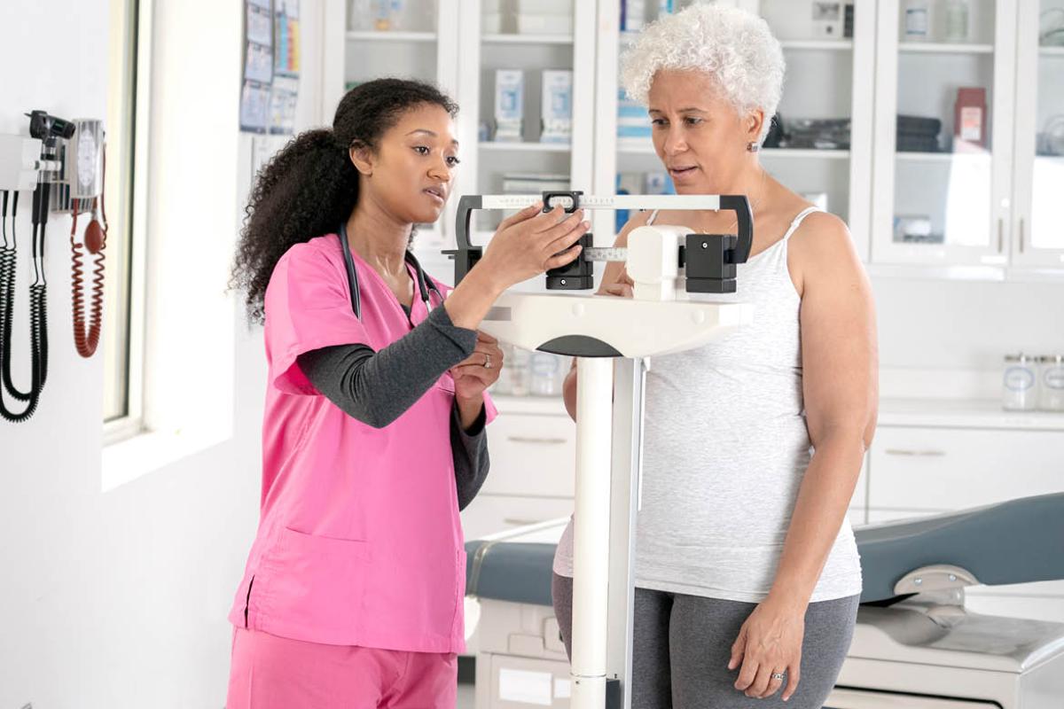 Woman being weighed in physician's office