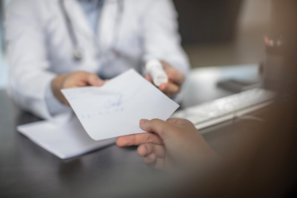 Physician handing patient prescription