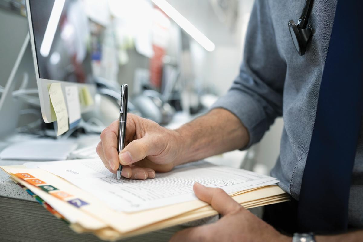 Physician filling out a form