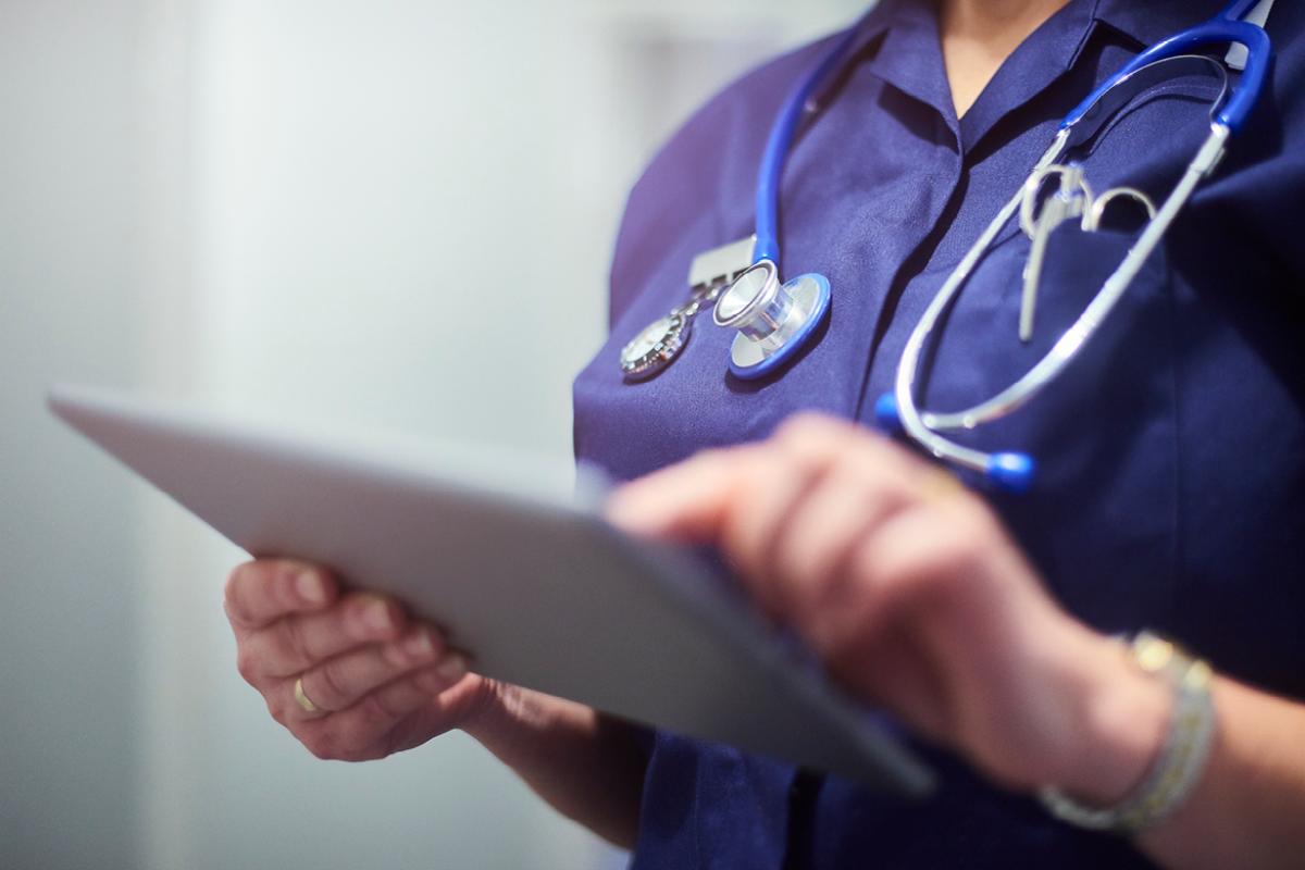 Health care professional using a tablet