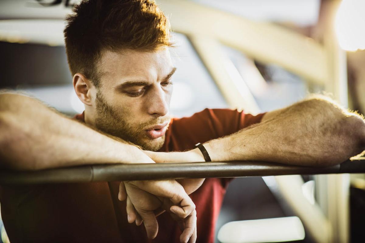 Man in red tee shirt short of breath