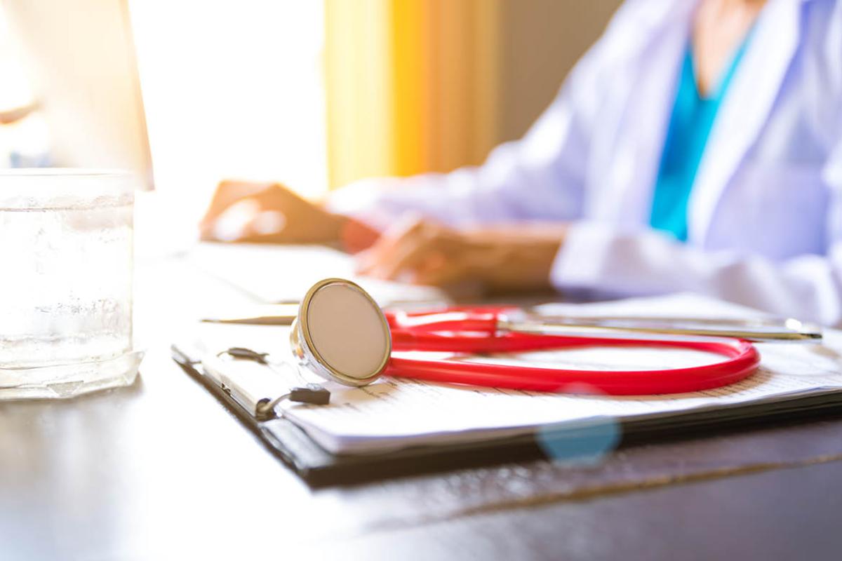 Stethoscope and notes next to a physician
