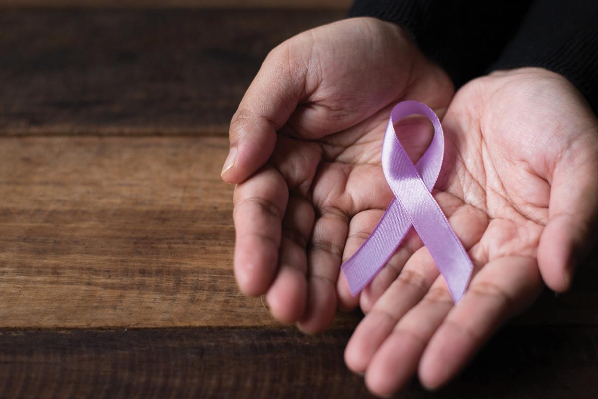 Breast cancer pink ribbon in hands