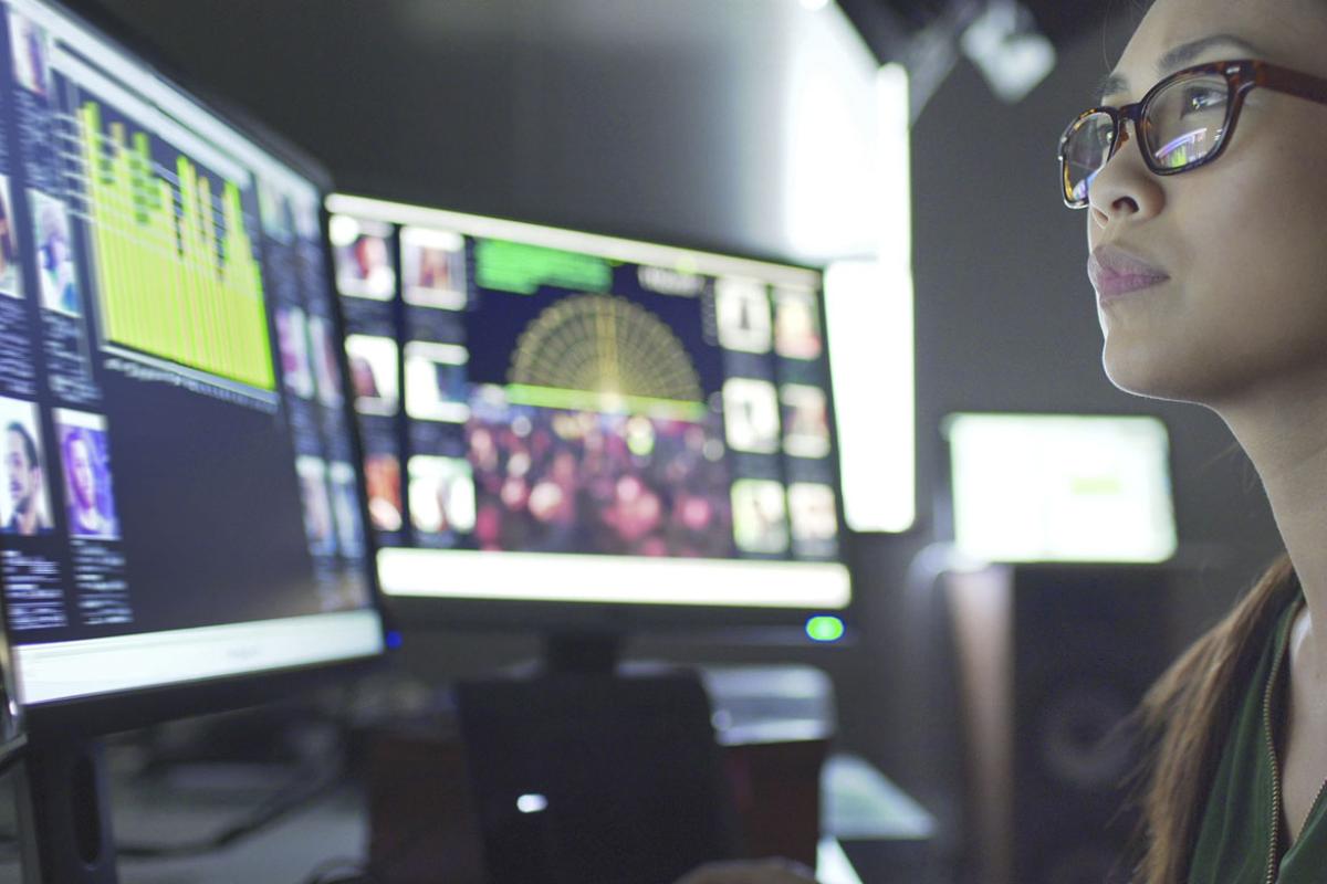 Young adult looking at computer monitor
