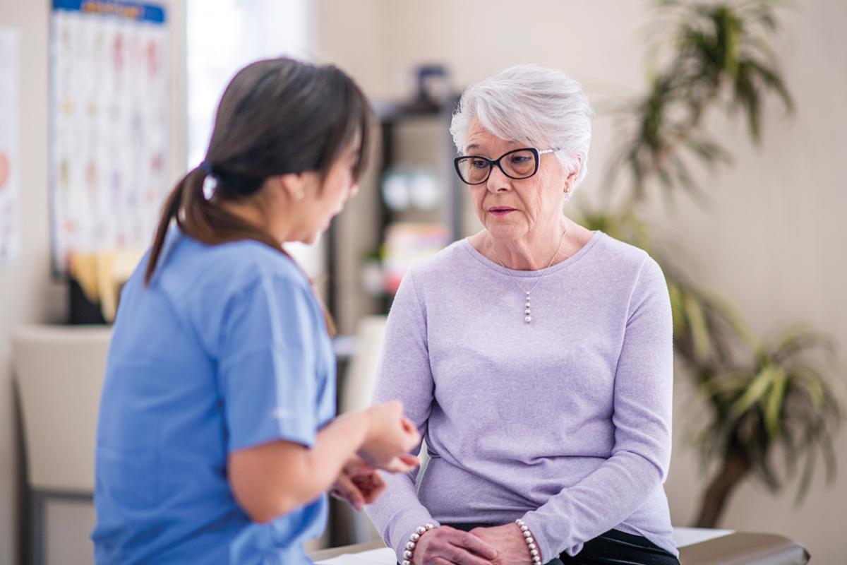 Physician talking with patient